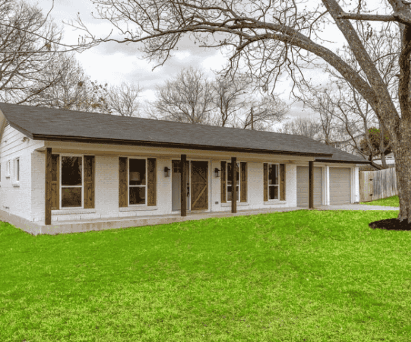 Exterior residential house painting project in Austin, TX featuring a clean white exterior with brown trim.
